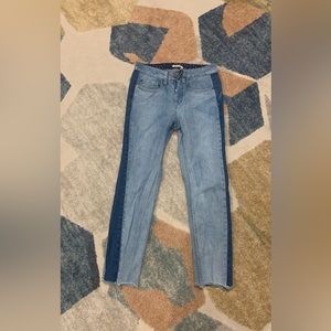 Split colored jeans, has frayed ends, with 4 buttons.